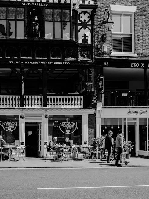 A row of commercial buildings on Jamaica Road in Bermondsey, London, featuring a mix of retail shops and cafes. The ground level includes a Starbucks Coffee store with large glass windows, and a brigh